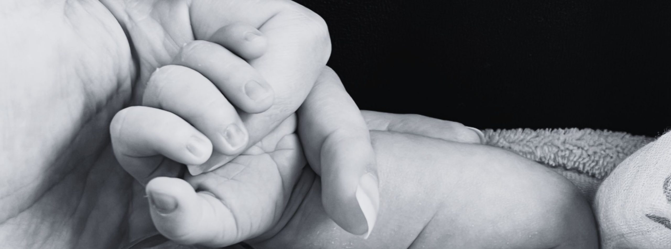 Mano de un bebé sujetando el dedo de su madre.